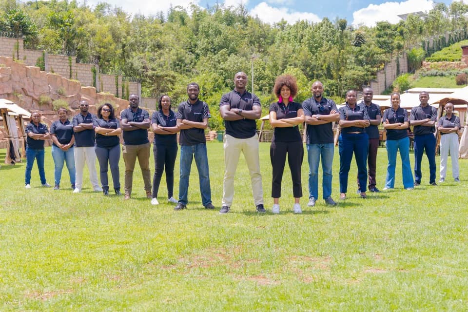 The Melanin Kapital team standing together on the lawn outside the office